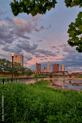 Scioto River and downtown Columbus Ohio skyline at John W. Galbreath Bicentennial Park at dusk photo