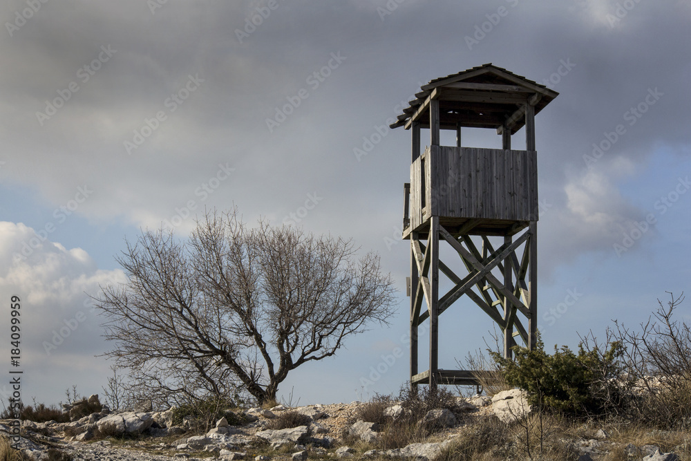 Old wooden fire protection watchtower on top of the hill Kozjak above of town Kastela in Croatia Old wooden fire protection watchtower on top of the hill Kozjak above of town Kastela in Croatia