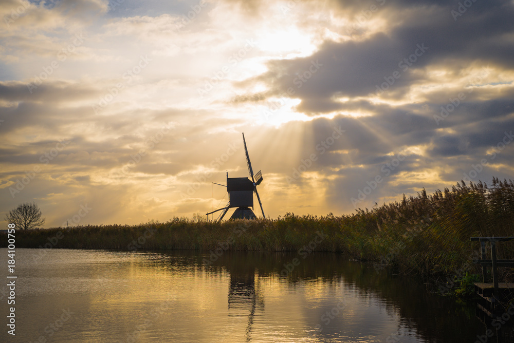 Old windmills in Kinderdijk at sunrise, Holland, Netherlands, Europe. Unesco world heritage site.