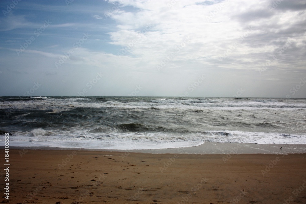 Outer Banks surf stirred by an approaching storm.