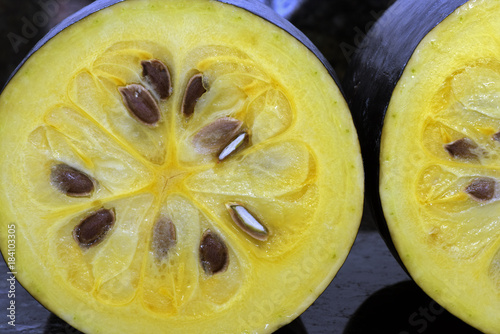 The exotic fruit jambolan sliced on black granite photo