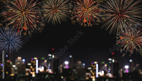 Festival fireworks at night in the city, blurred defocus Bokeh lights of building at night. For Holiday festival, New years and celebration background © SasinParaksa