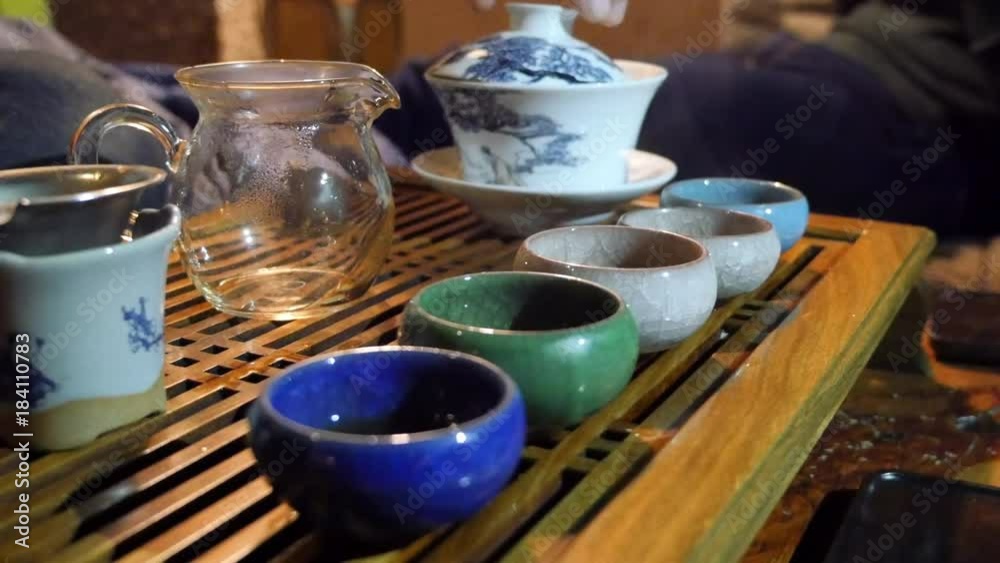 tea brewing ceremony. guy holds a tea ceremony in the company of friends. tea brewing ceremony. guy holds a tea ceremony in the company of friends.