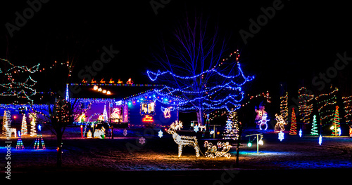 A Christmas light display in the front yard of a home on the drive of lights tour.