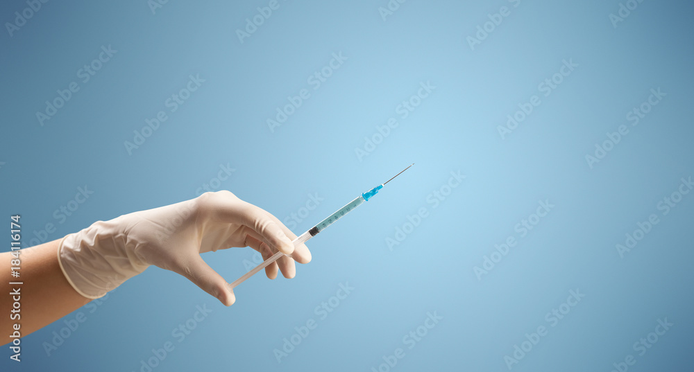 Female doctor holding syringe Female doctor holding syringe