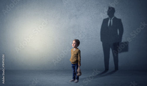Little boy with businessman shadow photo
