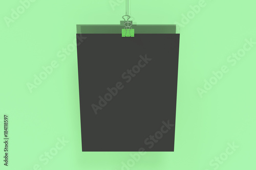 Blank black poster with binder clip mockup on green background