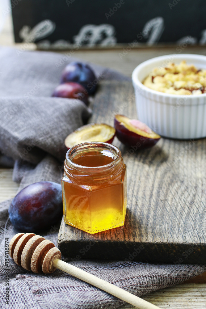 Jar of honey and plums Jar of honey and plums