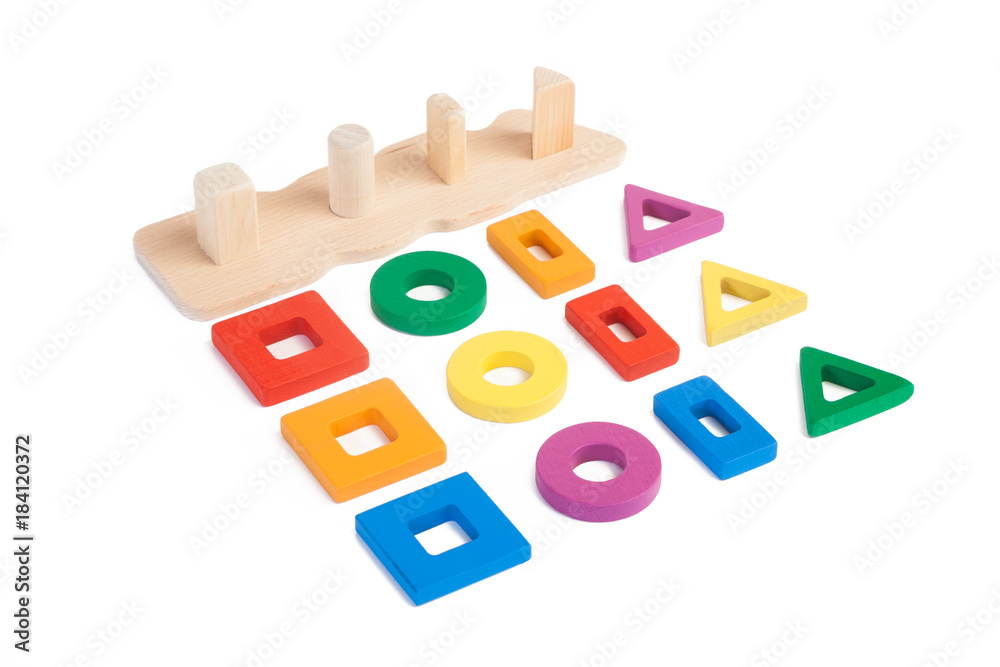 Photo of a wooden toy  children's sorter with small wooden details in the form of geometric shapes (rectangle, square, circle, triangle), in different colors   and in different order