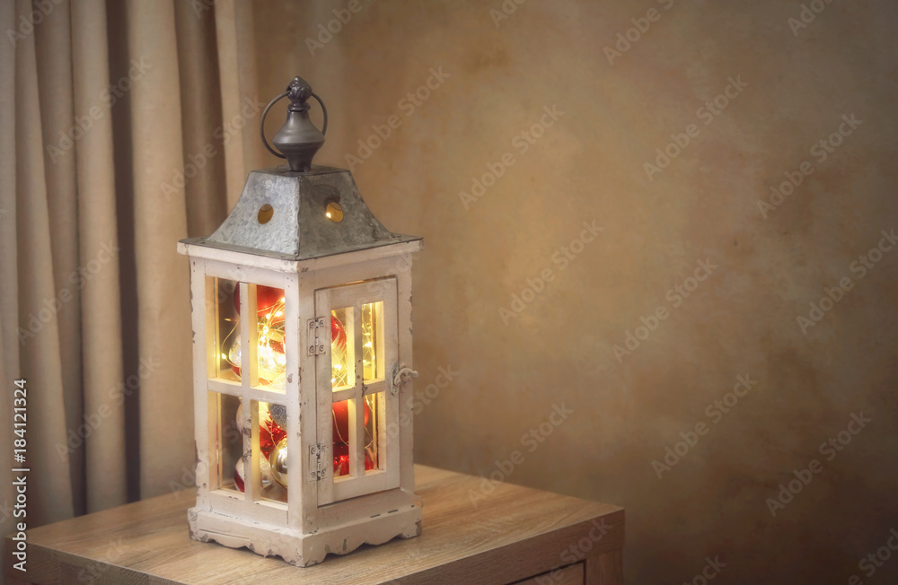 Christmas baubles and golden fairy lights in lantern Christmas baubles and golden fairy lights in lantern