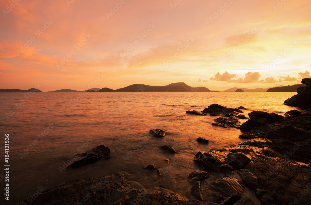 seascape nature in twilight and rock with colorful dramatic sky.
