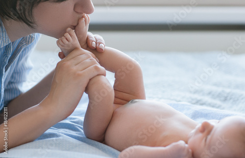 mother s love tenderness feet kiss newborn baby concept. family values. moments of happiness.