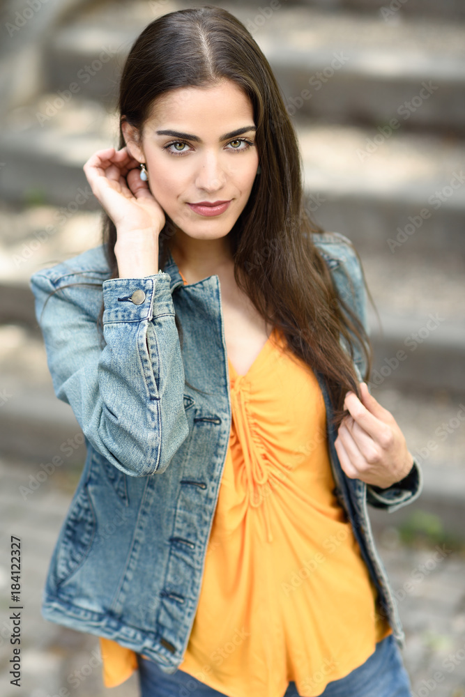 Woman with nice hair wearing casual clothes in urban background. Woman with nice hair wearing casual clothes in urban background.