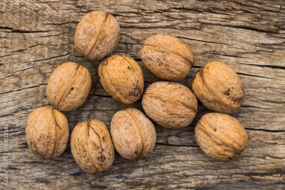 Walnuts on rustic old wooden table. Top view Walnuts on rustic old wooden table. Top view