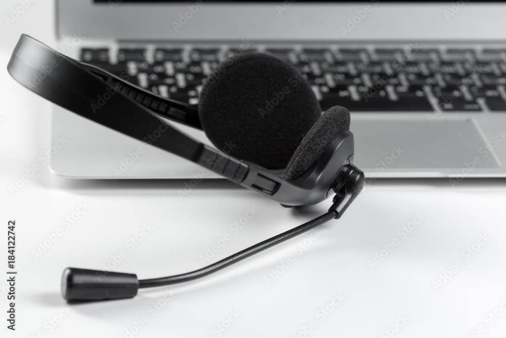 call center support concept. headset on keyboard computer laptop call center support concept. headset on keyboard computer laptop