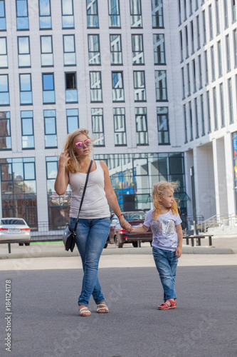 stylish mom and daughter wearing the same clothes