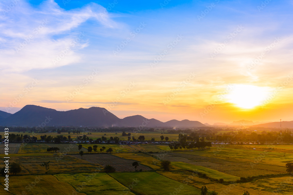 Sunset with mountain view background at countryside in Kanchanaburi province, Thailand.