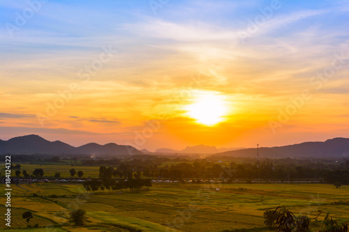 Sunset with mountain view background at countryside in Kanchanaburi province, Thailand.