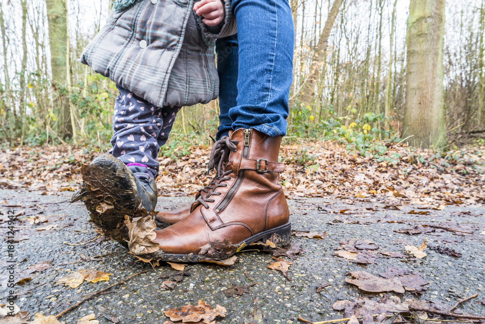 Mud on boots of mother and daughter Mud on boots of mother and daughter