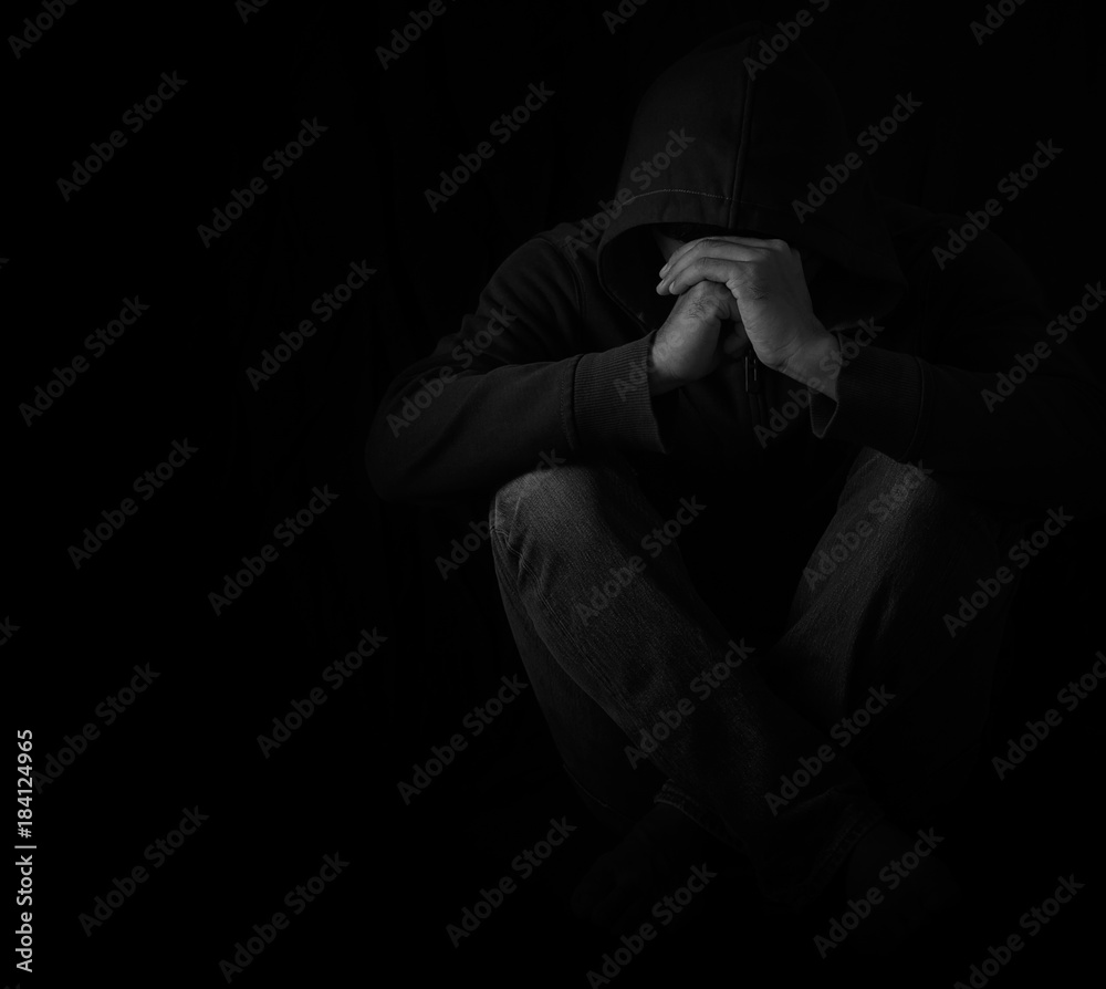 Young man sitting alone in dark room with depressed and anxiety ...