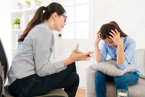 young girl sitting on psychology clinic sofa