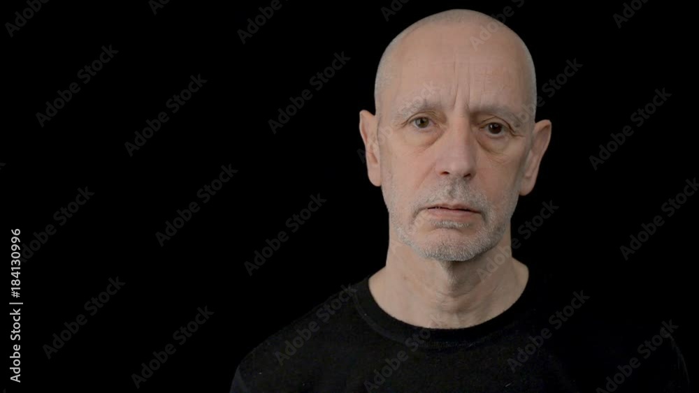 Portrait of a handsome natural adult man with brown eyes. He is very tired, sad and depressed. Black background Portrait of a handsome natural adult man with brown eyes. He is very tired, sad and depressed. Black background