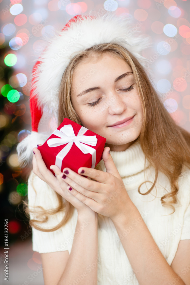 Happy young woman holding christmas present box Happy young woman holding christmas present box