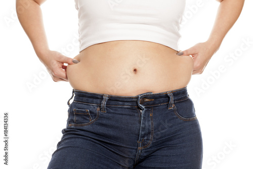 woman pinches her fat on her waist © vladimirfloyd