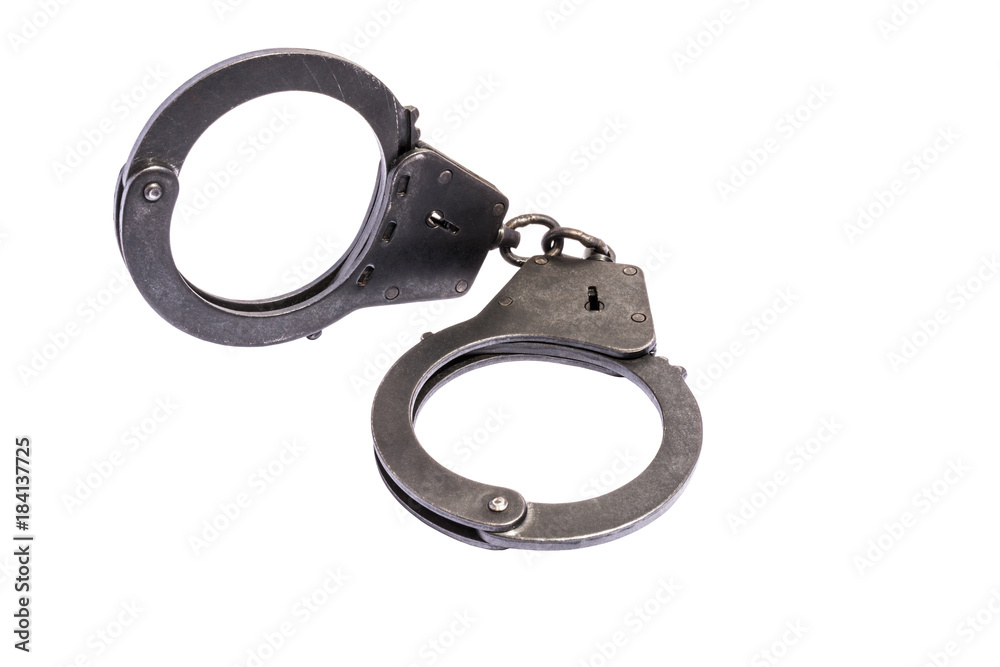 black metal handcuffs with small scratches on white background black metal handcuffs with small scratches on white background
