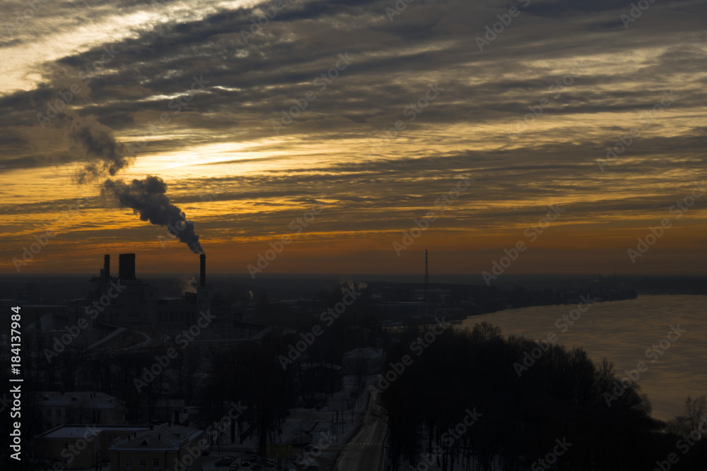 The city in the evening, a wide river, the smoke that falls from the chimney and the unusually beautiful sky.