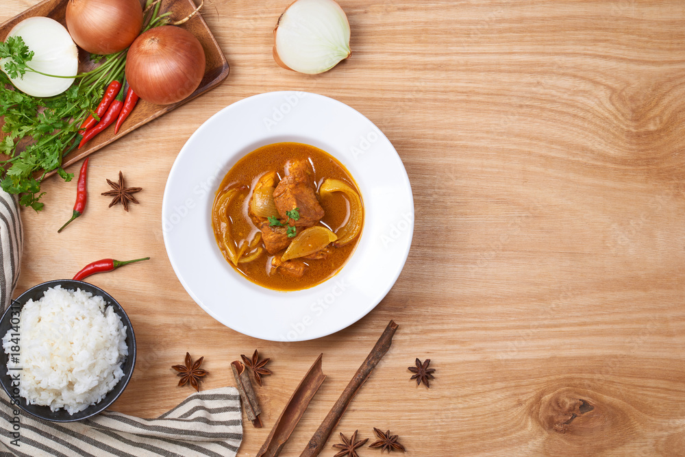 spicy chicken and rice on wooden background spicy chicken and rice on wooden background