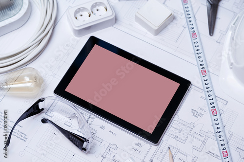 Construction drawing with tools and tablet with blank screen