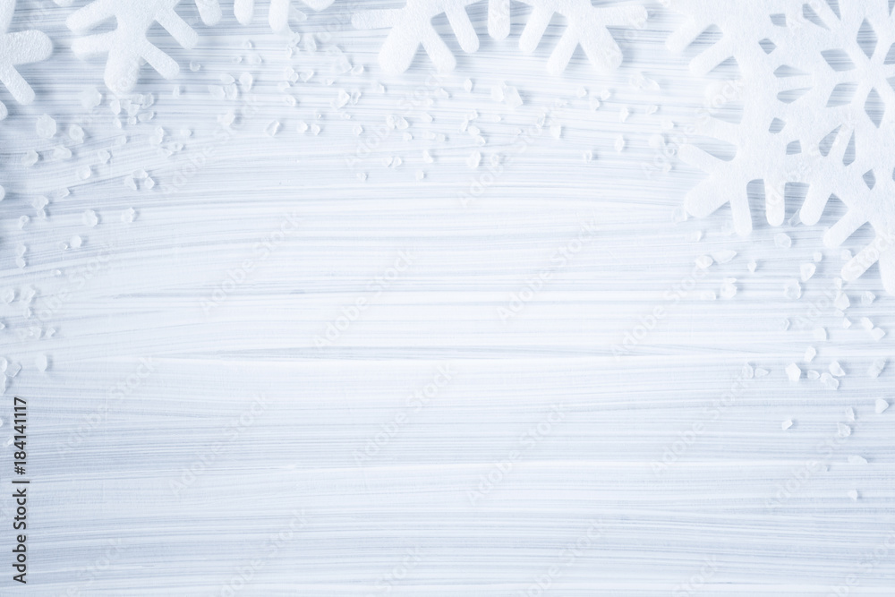 White artificial snowflakes on the cold, frosty wooden background. Mock up for holiday post card and Christmas offers as advertising or other ideas. Winter time concept. Empty place for a text. - obrazy, fototapety, plakaty 