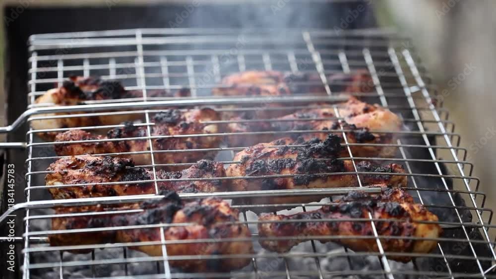 On the barbecue grilled chicken on the coals. Cooking. On the barbecue grilled chicken on the coals. Cooking.