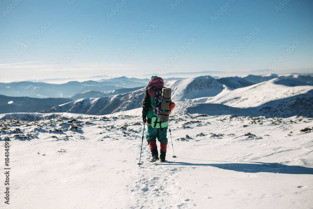climber walking downhill in winter