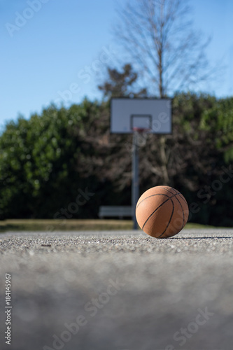 Basketball ball in basketball playground court into park