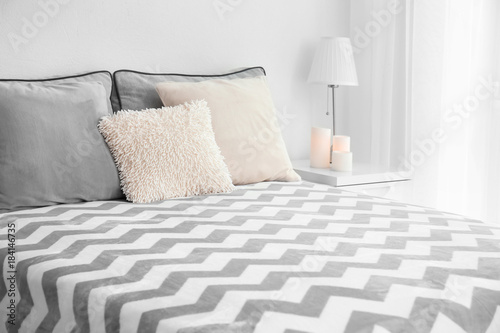 Fototapeta Naklejka Na Ścianę i Meble -  Comfortable bed with cushions in room
