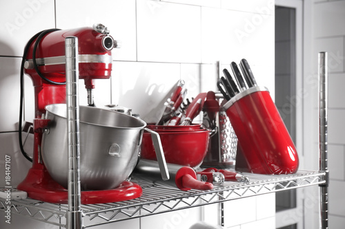 Shelving with kitchen utensils and cutlery in bakery
