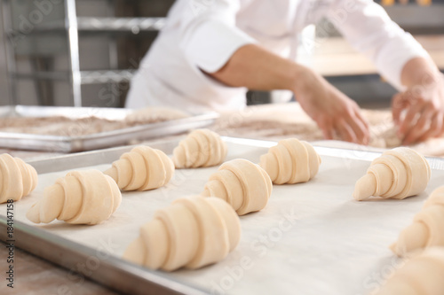 Raw crescent rolls on table in bakery