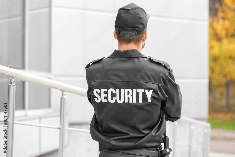Obraz premium Male security guard near building outdoors