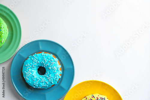 Plate with blue donut on white background