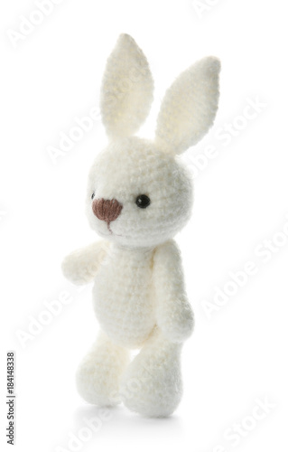 Cute knitted toy bunny on white background