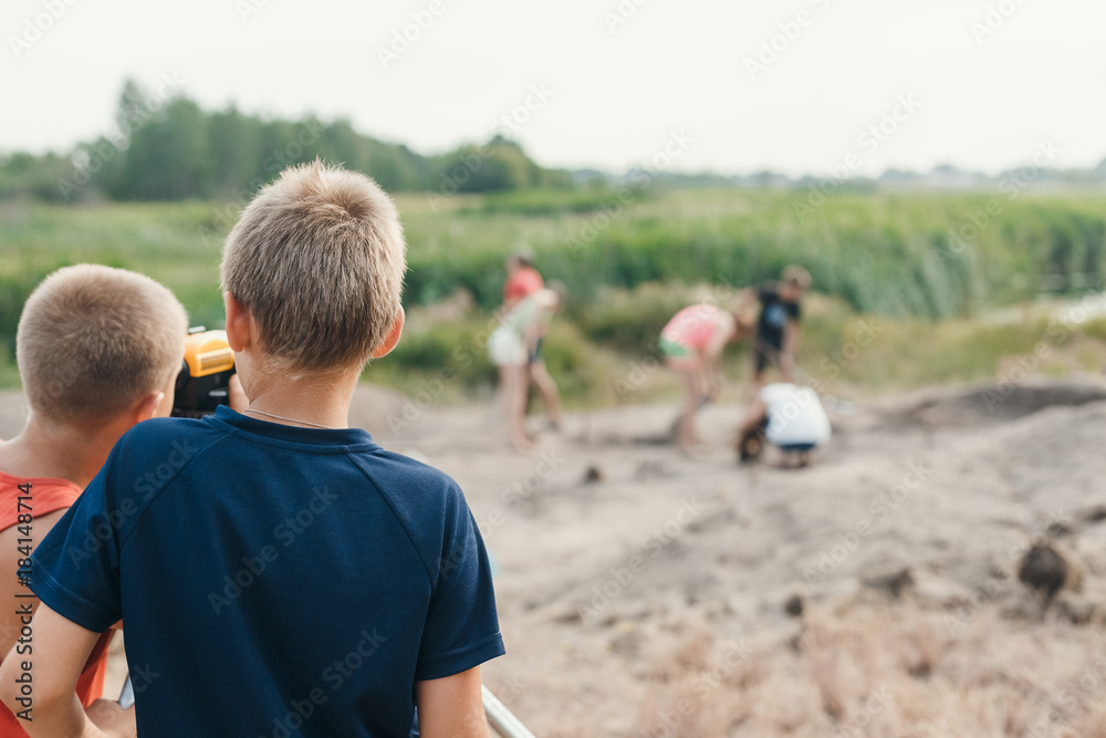 Fototapeta premium little boy archaeologist makes the measurement depends on the optical level