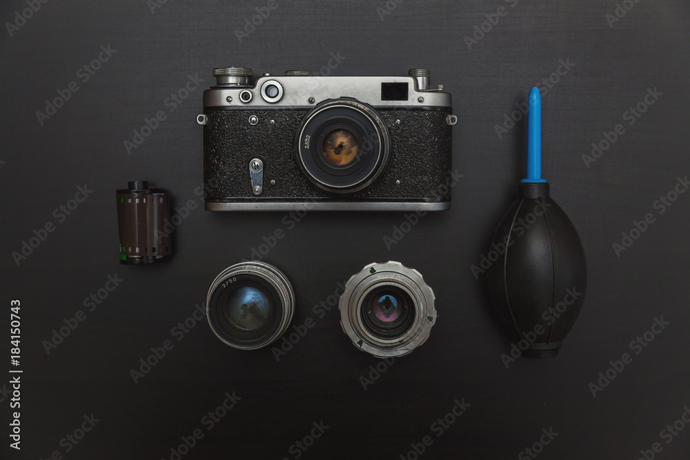 Vintage Film Camera And Accessories On Black Wooden Background Technology Development Concept. Top View