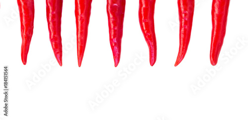 red hot chili peppers, popular spices concept - decorative arrangement of seven colorful pods of chili on isolated background, top view, flat lay, free space for text