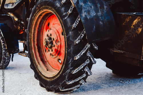the wheels of the tractor in the snow