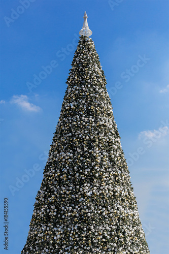 Big christmas decorated pine tree close up, white lights. Christmas decorations are lights and baubles. Happy new year, christmas celebration lights