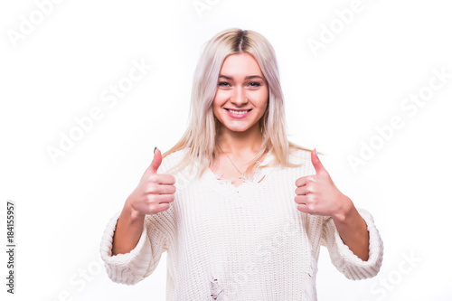 Attractive teenage girl showing thumbs up on white background. photo