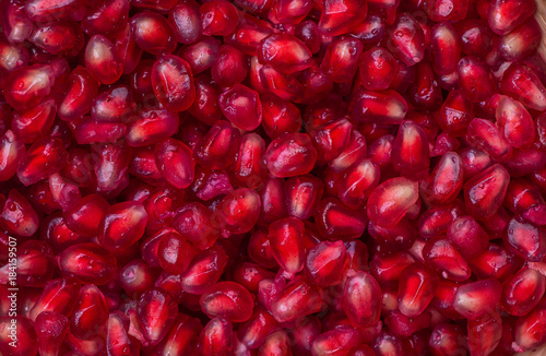 Dissected fruit fresh red pomegranate texture, background top view macro. 