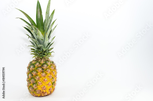 Fresh, healthy single pineapple close up shot isolated on white background.